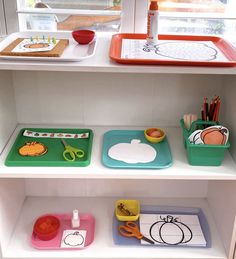 the shelves are filled with different types of trays and cutting mats for children's arts and crafts