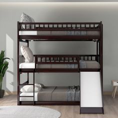 a bunk bed with two sets of mattresses on the bottom and one set below