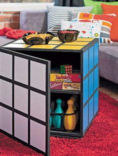 a rubik cube coffee table is shown in this living room setting with red carpet