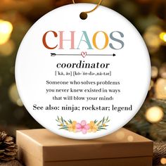 a christmas ornament with the words chaos and an image of a gift box