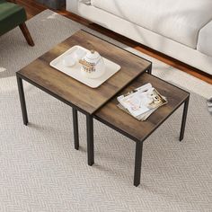 two wooden tables sitting on top of a carpeted floor next to a couch and coffee table