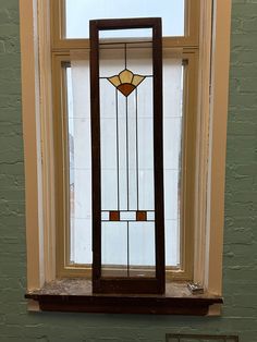 a stained glass window sitting on top of a wooden shelf