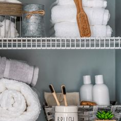 towels and other bathroom items on shelves in a closet