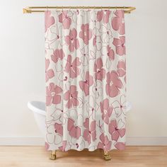 a pink flower shower curtain hanging on a wall next to a bathtub in a bathroom