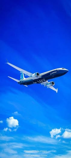 an airplane is flying through the blue sky with clouds in the background