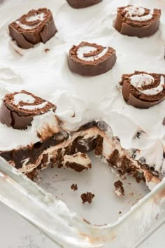 a pan filled with chocolate desserts covered in frosting