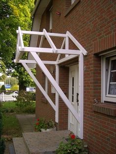 a white trellis on the side of a brick building