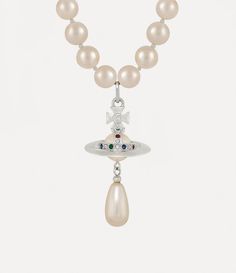 In the late 1980s, Vivienne Westwood introduced her iconic pearl concept at the Harris Tweed fashion show, featuring a single-strand choker. Our One Row Pearl Drop choker reflects the elegant form of the original design, highlighting a three-dimensional orb motif adorned with crystal accents and a dangling teardrop pearl. 1987 Fashion, Jewelry Vivienne Westwood, Vivienne Westwood Jewelry, Tweed Fashion, Vivienne Westwood Jewellery, Luxury Necklace, Pearl Necklaces, Harris Tweed, Pearl Choker