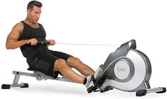 a man is using an exercise machine to pull his leg up on the ground while working out