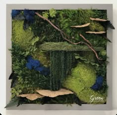 an art work made out of moss and leaves