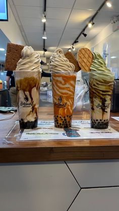 three different types of ice cream in cups