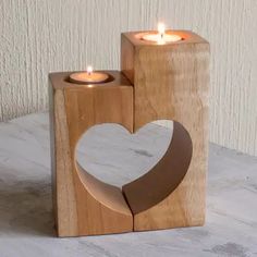 two wooden blocks with candles in the shape of a heart