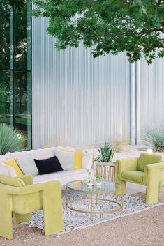 a living room filled with furniture next to a tree