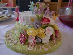 a cake decorated with flowers and candles on a table