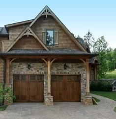 a large house with two garages in front of it