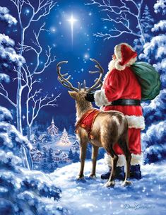 a woman kneeling down next to a reindeer in front of a man dressed as santa claus