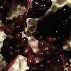 a close up view of some food with cream and black olives