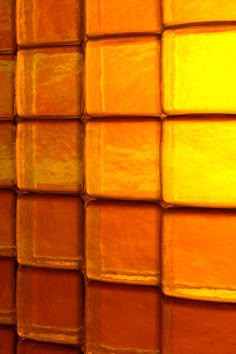 an orange and yellow background with squares in the middle, as if it were made out of clay