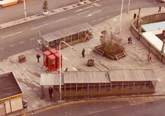 an aerial view of a bus station with people walking around