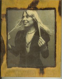 an old photo of a woman with long hair