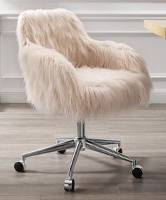 a white chair with wheels and a fur seat cover on it's armrests