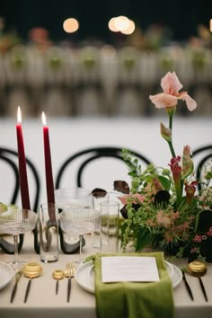 the table is set with place settings and candles