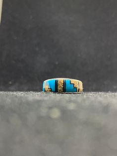 Contemporary handmade Native American Navajo inlay Jasper, sleeping beauty turquoise & Jet inlay ring sterling silver mens band ring Size 11 by A.T This ring is made with the famous Zuni style; Inlay Inlay is the process of hand-cutting each stone to fit in a flush surface. As you can see, the stones are also slightly raised to give it a textured feeling. There are 33 hand cut stones soldered and inlayed into a silver bezel with gorgeous silver work surrounding the stones. Nice thick silver. Wei Mens Band Rings, Silver Work, Sleeping Beauty Turquoise, Picture Jasper, Mens Band, Sterling Silver Mens, Band Ring, Band Rings, Nativity