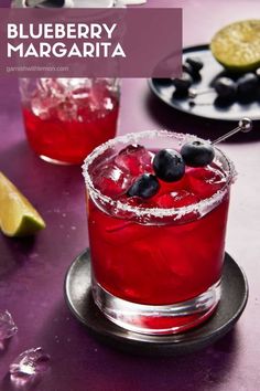 blueberry margarita with lime and black olives on the rim