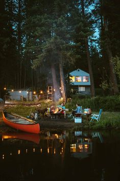 there is a boat that is sitting on the water at night with people around it