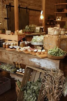 an open air market with lots of food on the counter and baskets full of vegetables