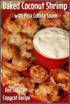 a red plate topped with fried shrimp next to a bowl of ranch dressing on top of it