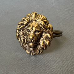 Lion's Head Cuff...  I attached a LARGE antiqued brass plated brass lion's head stamping to the top of a silver plated cuff bracelet.  The large lion head stamping comes from very old tooling! This lion head cuff is adjustable.  Women - fits medium to large size wrist  Men - fits small to medium size wrist You will receive this fabulous lion's head cuff gift wrapped!  A perfect gift for someone with a Leo birthday! Nature inspired necklaces are listed here! https://www.etsy.com/shop/DaysLongGone Lion Oc, Lion Jewellery, Birthday Nature, Largest Lion, Lion Bracelet, Lion Jewelry, Cowardly Lion, Leo Birthday, Cosplay Jewelry