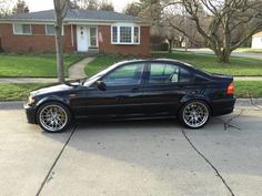 a black car parked in front of a house