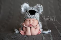 a newborn baby wearing a crocheted koala hat