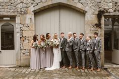 a group of people that are standing in front of a door with flowers on it