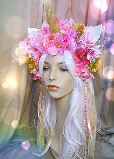 a mannequin head with pink flowers and unicorn horns on it's head