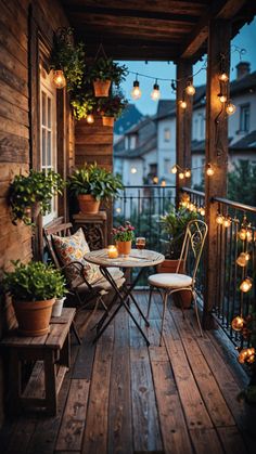 an outdoor porch with lights strung from the ceiling and potted plants on the table