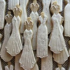 decorated cookies in the shape of brides and grooms