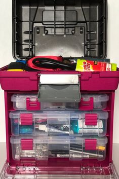 a pink tool box filled with tools and supplies