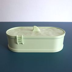 a white container sitting on top of a blue table