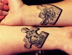 two people with matching tattoos on their arms, one has a puzzle piece in the shape of a heart