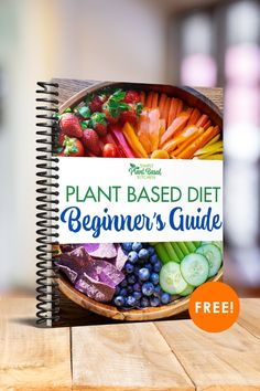 the plant based diet beginner's guide is on top of a wooden table