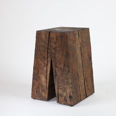 a wooden stool made out of two pieces of wood