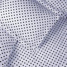 closeup of white and black polka dot fabric with very small dots on the pattern