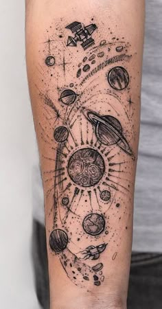 a man with a tattoo on his arm that has planets and stars all over it