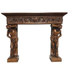 an antique carved wood fireplace mantel with cherubs on it's sides