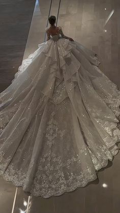 a woman in a wedding dress walking down the runway