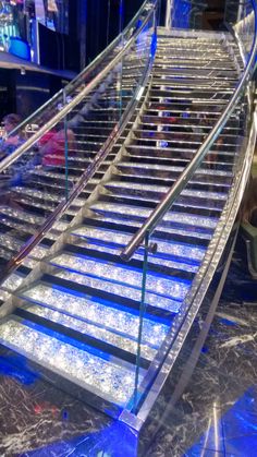 an escalator with blue lights on it