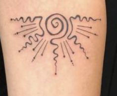 a tattoo on the leg of a woman with sun and rays coming out of it