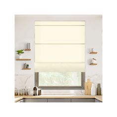 a kitchen with white walls and countertops has a large window in the center that is covered by roman shades